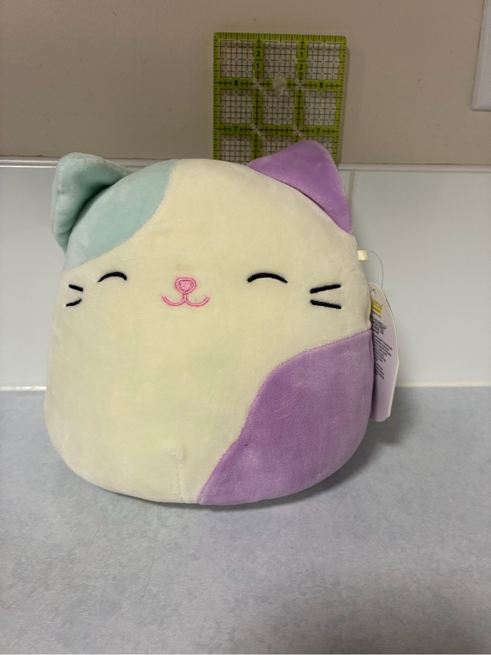 Squishmallows Cora, Cat Plush - Cream with Purple & Mint Accents 7”
